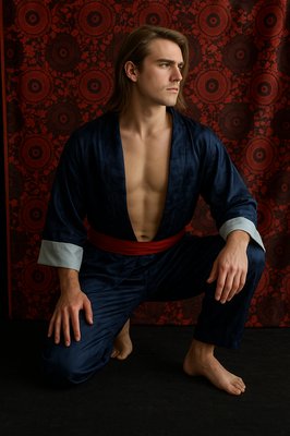 a man in a kimono poses for a picture