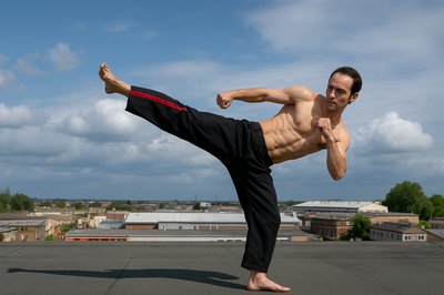 a man doing a kickbox pose on a roof