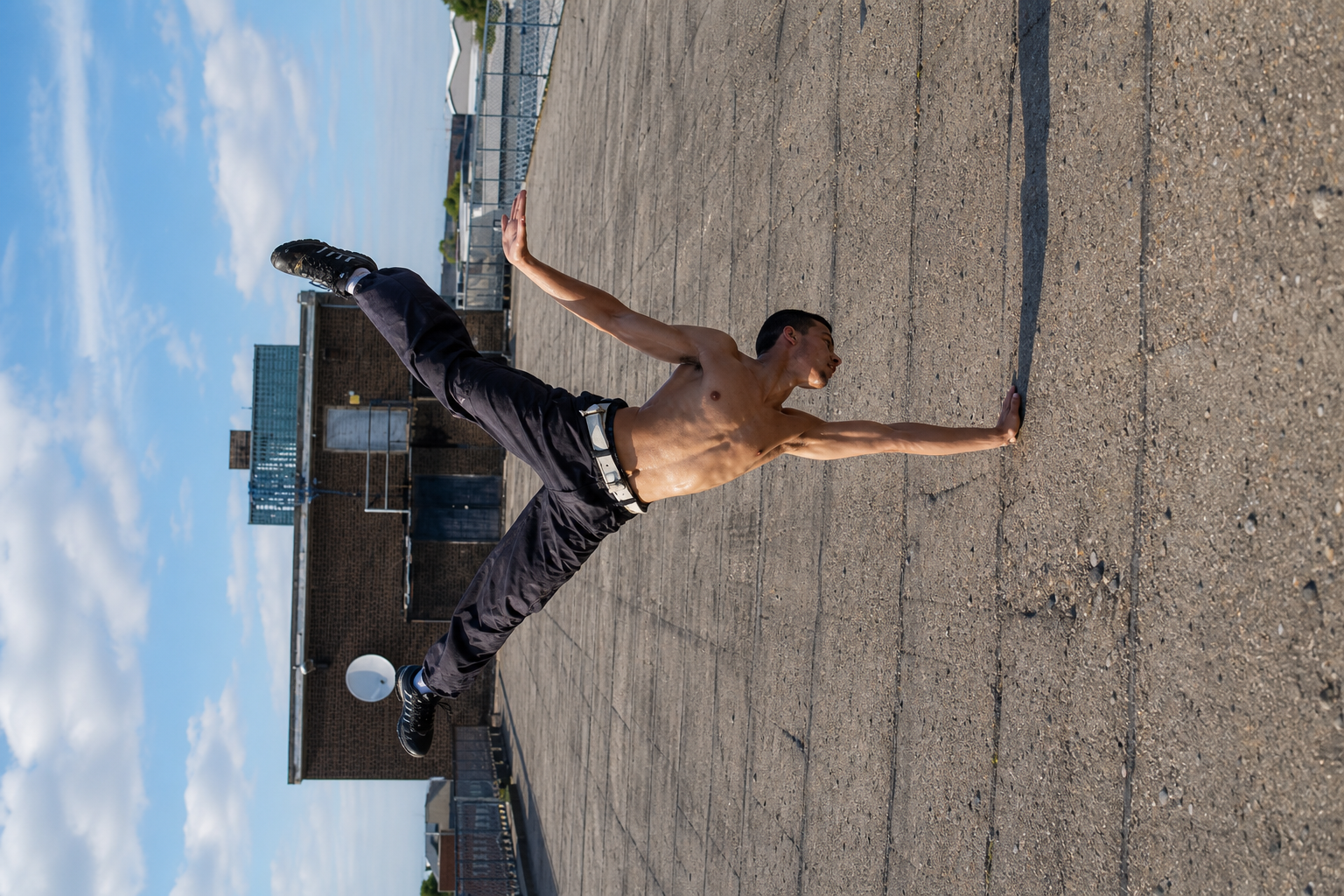 a man with no shirt is playing frisbee