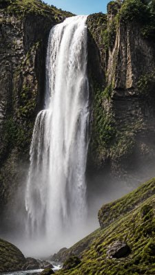 towering waterfall cascading down a cliff