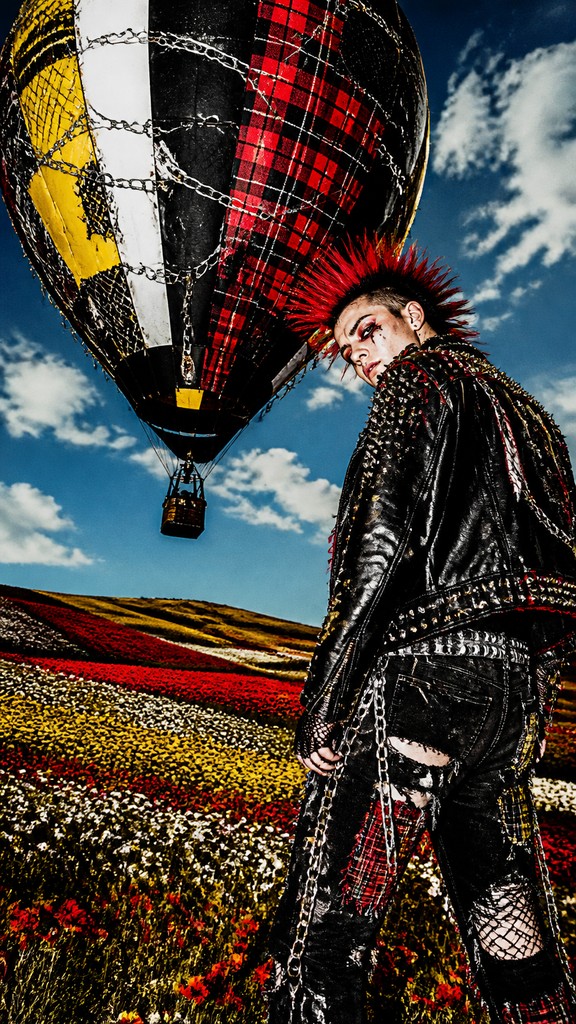 a hot air balloon drifting over rolling flower fields on a sunny day, cheerful, no text