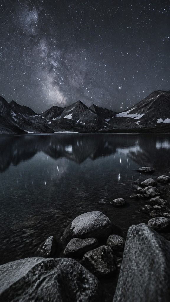 a tranquil mountain lake beneath a starry night sky, no people, no text