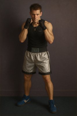 a man posing for a picture with his boxing gloves on