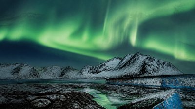 a flowing aurora over snowy peaks, wide sweeping composition, no people, no text