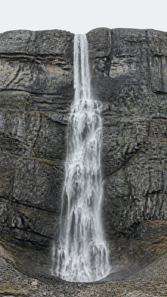 towering waterfall cascading down a cliff