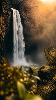 towering waterfall cascading down a cliff