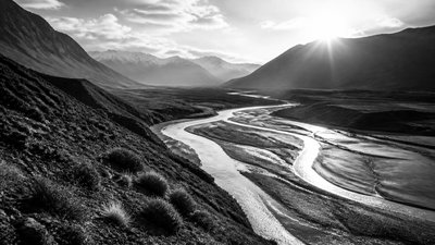 a vast valley with a river winding toward distant mountains at sunrise, no people, no text