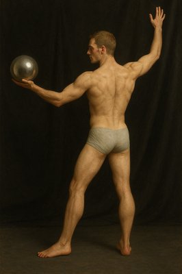 a man in underwear holding a silver ball