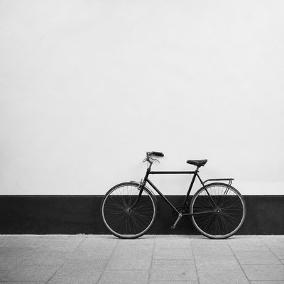 bicyle resting against a wall — Minimalist Photography Style