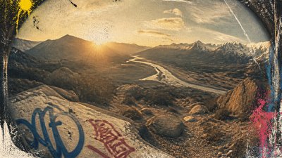 a vast valley with a river winding toward distant mountains at sunrise, no people, no text