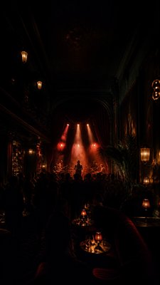 a live music scene with a glowing stage and silhouetted crowd, energetic vertical composition with open space at the top, no text
