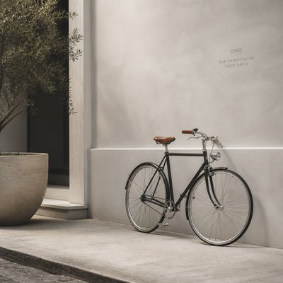 bicyle resting against a wall — Minimalist Fashion Design