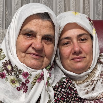 a couple of women sitting next to each other
