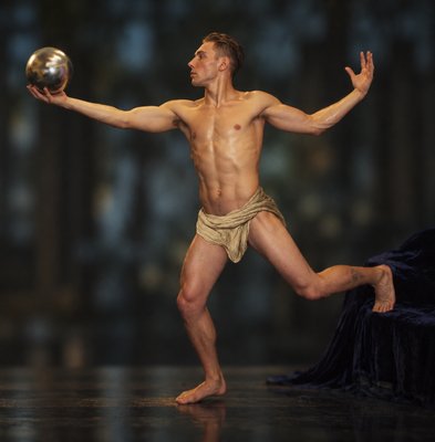 a man with no shirt is holding a ball