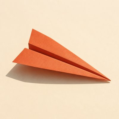 a paper plane, clean minimal composition on a plain background, no text