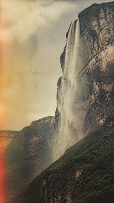 towering waterfall cascading down a cliff