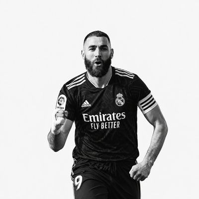 a man with a beard is running with a soccer ball