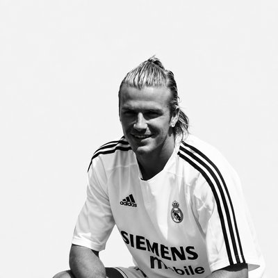 a man sitting down with a soccer ball in his hand