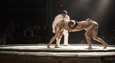 a couple of men standing on top of a wrestling ring