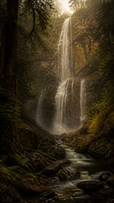 towering waterfall cascading down a cliff