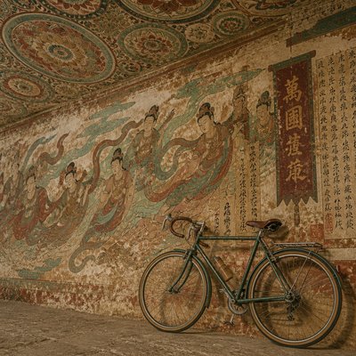bicyle resting against a wall