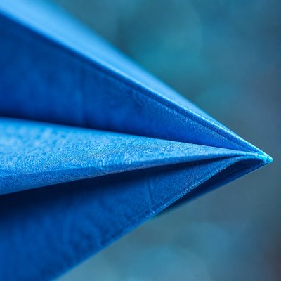 a paper plane, clean minimal composition on a plain background, no text