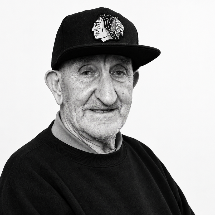a black and white photo of a man wearing a hat