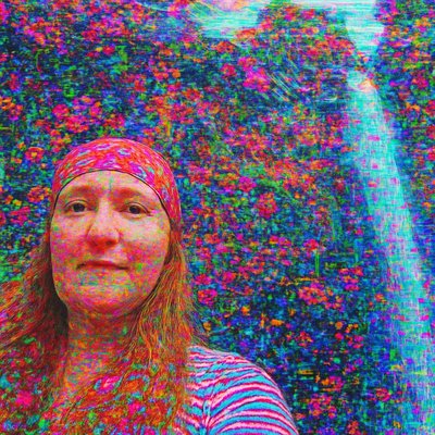 a woman standing in front of a colorful waterfall