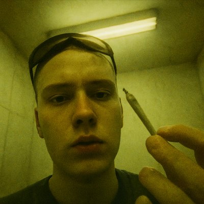 a man holding a cigarette in front of his face