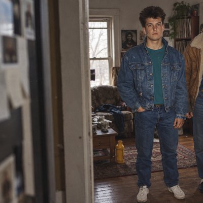 two young men standing in a living room