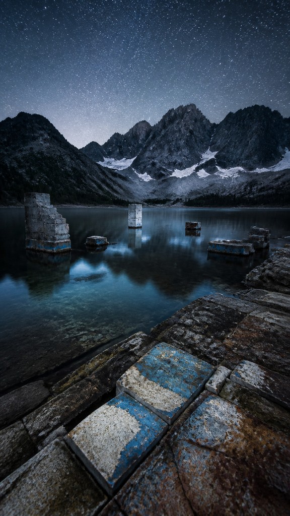 a tranquil mountain lake beneath a starry night sky, no people, no text