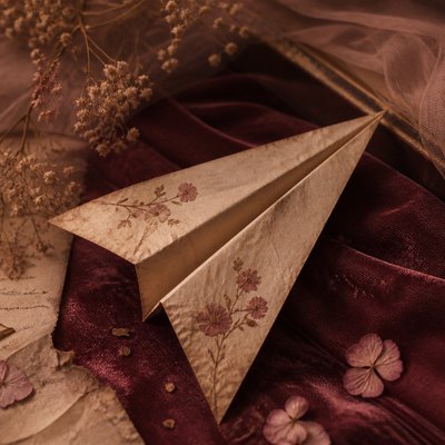 a paper plane, clean minimal composition on a plain background, no text