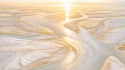 a wide river delta seen from above at sunset, no people