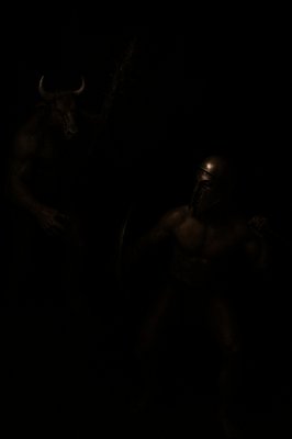 a man with a horned head standing in the dark