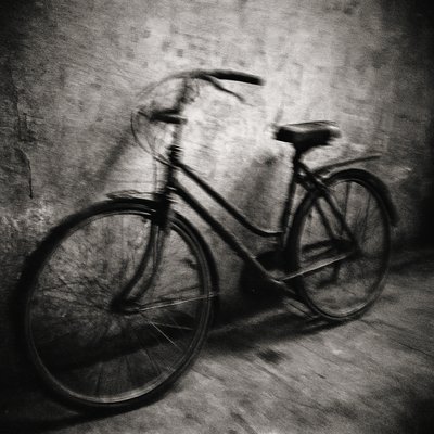 bicyle resting against a wall