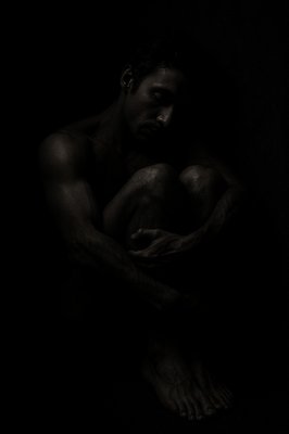 a black and white photo of a naked man