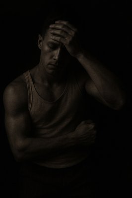 a black and white photo of a man in a tank top