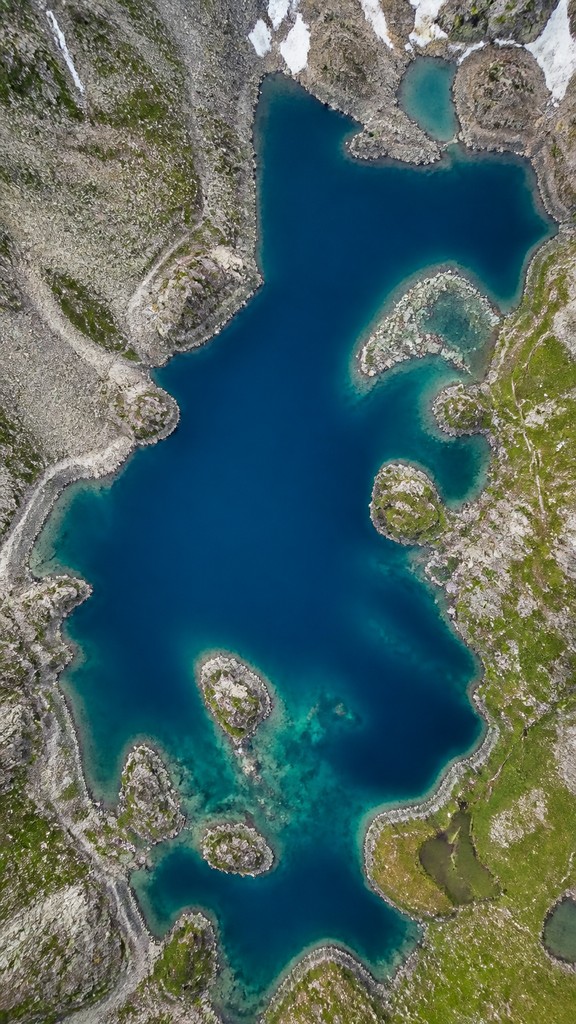 a tranquil mountain lake beneath a starry night sky, no people, no text