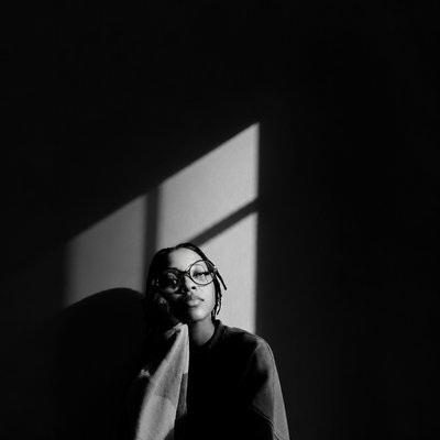 a black and white photo of a woman wearing glasses