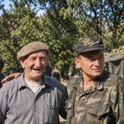 a couple of men standing next to each other