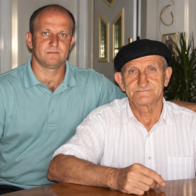 a man sitting next to a man sitting at a table