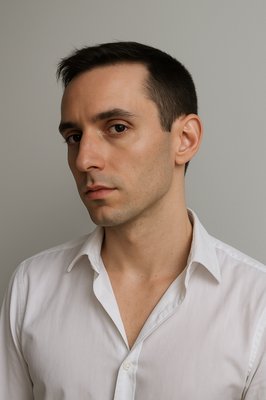 a man in a white shirt is posing for a picture