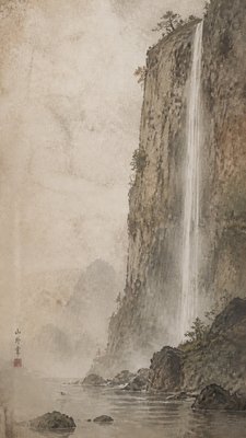 towering waterfall cascading down a cliff