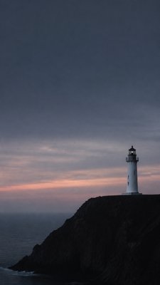 a lone lighthouse on a cliff at dusk under a dramatic sky, no text or lettering