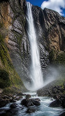 towering waterfall cascading down a cliff