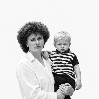 a black and white photo of a woman holding a child