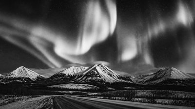 a flowing aurora over snowy peaks, wide sweeping composition, no people, no text