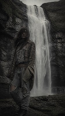 towering waterfall cascading down a cliff