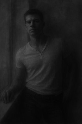 a black and white photo of a man in a white shirt