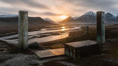 a vast valley with a river winding toward distant mountains at sunrise, no people, no text